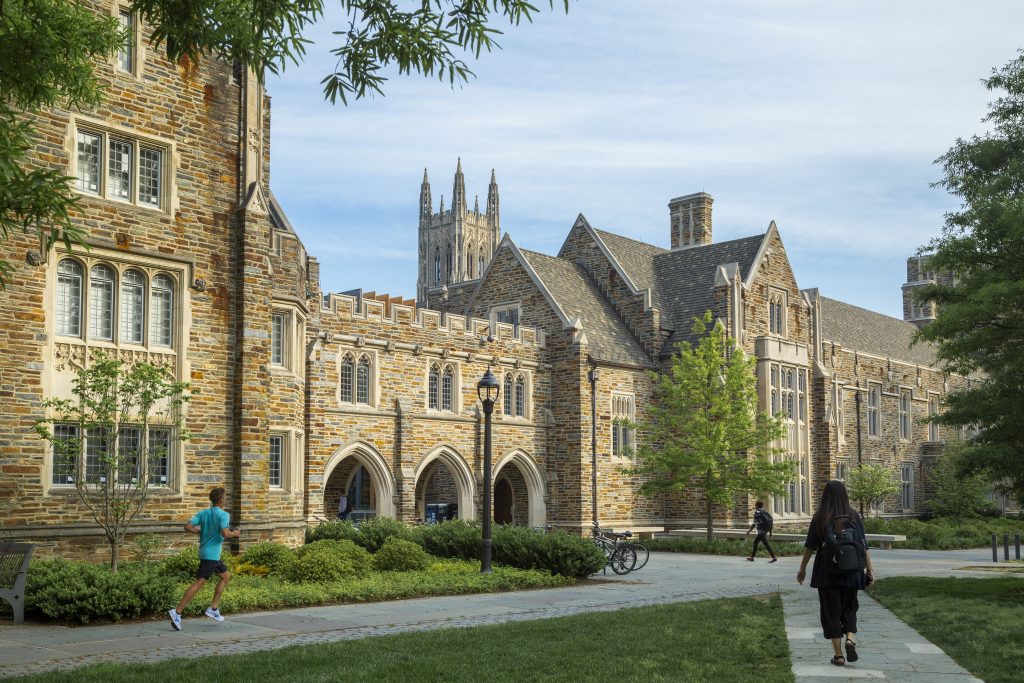 Students walk across the Abele Quad on a beautiful Spring morning. Duke Chapel is in view in background.